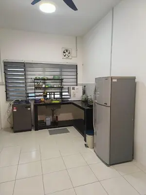 a kitchen with a desk and a refrigerator at Rumah SK in Batu Kurau