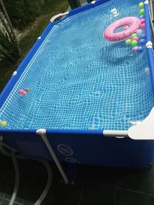 a swimming pool with alatable at Homestay Mariah in Ipoh