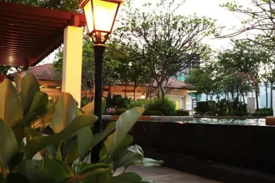 a street light sitting next to a fence at 2 bedroom Suite with Sea View At Straits Quay in Tanjong Tokong
