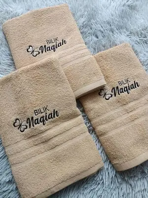 two towels with the words buy marmalaria on them at Bilik Naqiah in Gerik