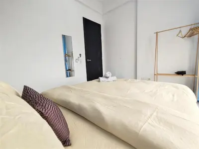 a large bed in a white room with a large bed sidx sidx sidx at Skyblue 2 Rooms Apartment, 4 plus 2 Pax at Urban Suites in Jelutong