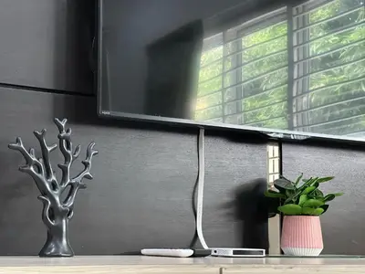 a remote control on a table next to a window at Landed House Gelugor 5BR 3B-20pax by 3C in Gelugor
