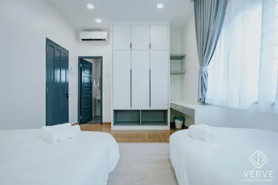 two white beds in a room with a black door at Ipoh Mansion House 25 by Verve in Ipoh