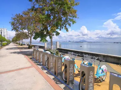 a row of bikes parked next to the water at NEW - Panorama Komtar SeaView Meritime Suites in Jelutong