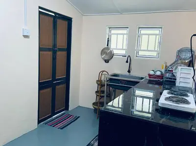 a kitchen with a counter with a sink and a stove at Inap Desa R'Sawit - A dan B in Sekincan