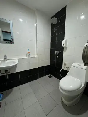 a bathroom with a toilet and a sink at Hotel Pinji Ipoh in Ipoh