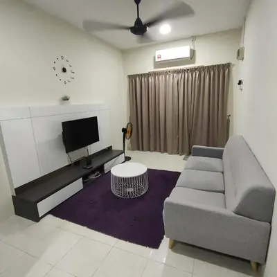 a living room with a couch and a tv at Mimms Homestay Teluk Intan in Teluk Intan