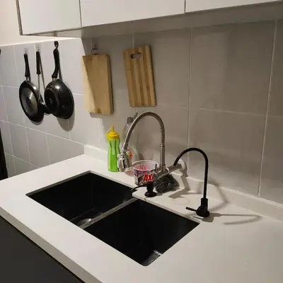 a kitchen counter with a sink in a kitchen at Mimms Homestay Teluk Intan in Teluk Intan