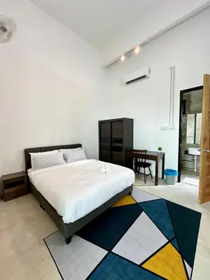 a bedroom with a large bed and a table at Ferringhi Inn 51 in Batu Ferringhi