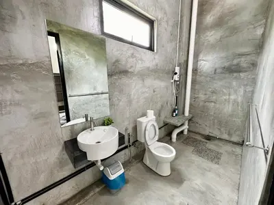 a bathroom with a toilet and a sink and a mirror at Ferringhi Inn 51 in Batu Ferringhi