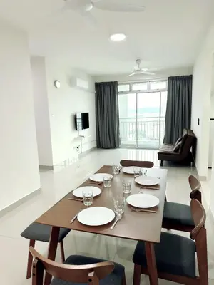 a dining room table and chairs in a living room at Tur16 SPlCE 10pax 4room Private House in Bayan Lepas