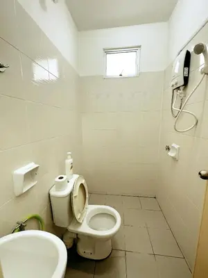 a white bathroom with a toilet and a sink at Tur16 SPlCE 10pax 4room Private House in Bayan Lepas