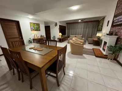 a living room with a wooden table and chairs at Sevenseas Family Home Copthorne Cameron Highland in Brinchang