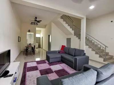 a living room with a couch and a tv at 4-Bedroom Homestay in Taiping, Perak in Kamunting