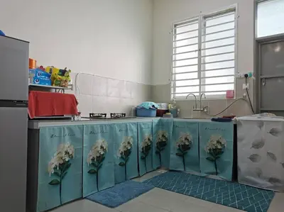 a kitchen with blue cabinets with flowers on them at 4-Bedroom Homestay in Taiping, Perak in Kamunting