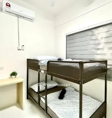 a bedroom with two bunk beds in a room at The Pancarona240 in Seri Iskandar