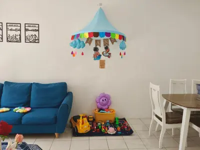 a living room with a blue couch and a table at Ian's Homestay Tanah Rata C Highlands in Tanah Rata