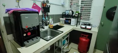 a small kitchen with a sink and a microwave at Ian's Homestay Tanah Rata C Highlands in Tanah Rata