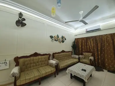 a living room with two couches and a ceiling fan at Teratak Ayuni with Private pool in Batu Gajah