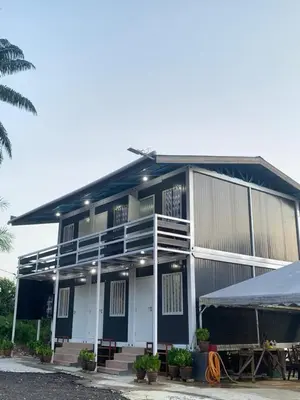 a building with a tent in front of it at Farhani Cabin Stay in Kampong Batu Lima