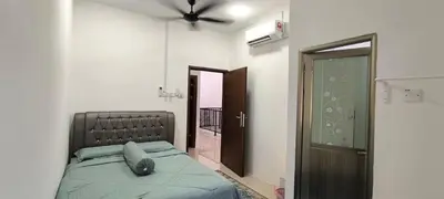a bedroom with a bed and a ceiling fan at AMI Homestay & Guest House in Gua Musang