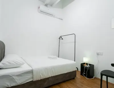 a white bedroom with a bed and a mirror at The Terraces by Aayu - 2 mins walk to Chulia Street in George Town