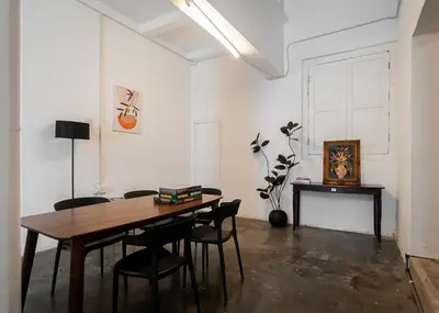 a dining room with a wooden table and chairs at The Terraces by Aayu - 2 mins walk to Chulia Street in George Town