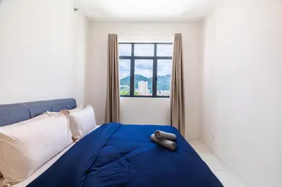 a bedroom with a blue bed and a window at The Sun Executive #BayanLepas #QueensbayMall #8 in Bayan Lepas