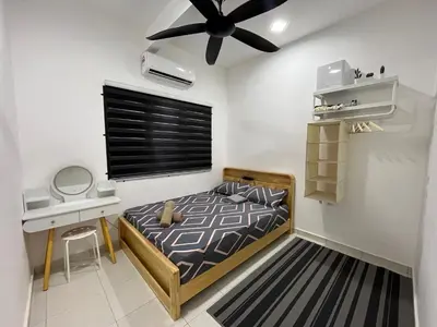 a bedroom with a bed and a ceiling fan at KN Homestay in Butterworth