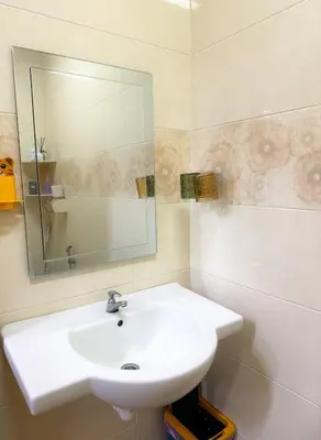 a bathroom with a white sink and a mirror at Happy Guest House Nibong Tebal \u5f00\u5fc3\u6c11\u5bbf\u9ad8\u6e0a\u533a in Nibung Tebal