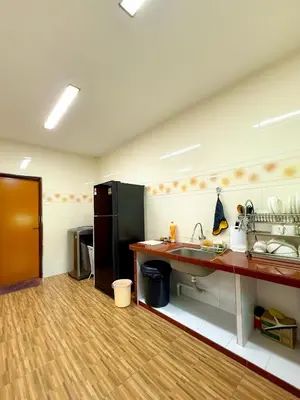 a large kitchen with a sink and a counter at Happy Guest House Nibong Tebal \u5f00\u5fc3\u6c11\u5bbf\u9ad8\u6e0a\u533a in Nibung Tebal