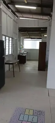 an empty room with desks and a table in a building at Bukit Limau rest house Merbau in Taiping