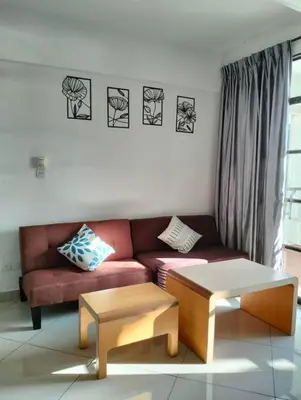 a living room with a couch and two tables at Marina Heights Home Suite Teluk Batik in Lumut