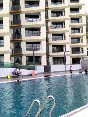 a swimming pool in front of a building at Marina Heights Home Suite Teluk Batik in Lumut