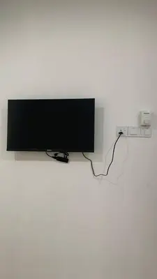 a flat screen tv hanging on a wall at Bilik Umar in Gerik