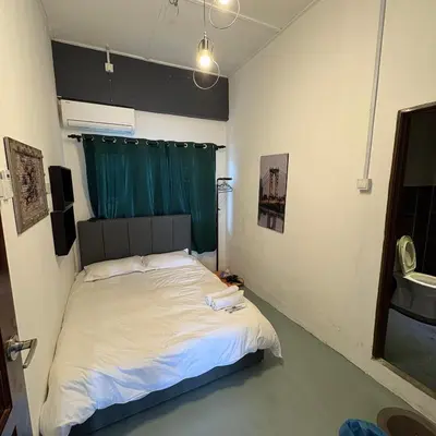 a bedroom with a bed with a green curtain at Ipoh Apartment Suites in Ipoh