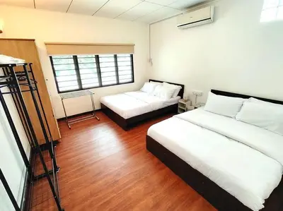 a bedroom with two beds and a window at PUTIH Ipoh SaltWater Pool BBQ 5Bed4Bath 19pax in Ipoh