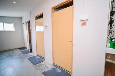 a row of doors in an empty room at Swing & Pillows - Armenian Victoria , Georgetown Penang in George Town
