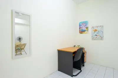 an office with a desk with a chair and a mirror at Sweet 9ight Menglembu Falim Homestay in Ipoh