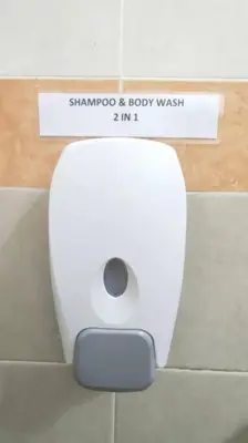 a white toilet in a bathroom with a sign at 66 Homestay 5 Min to Leaning Tower in Teluk Intan