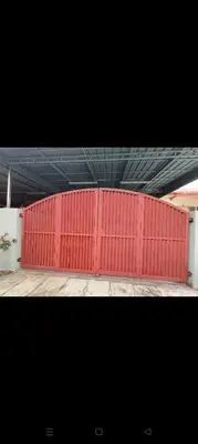 a red fence in front of a building at Mom House in Ipoh