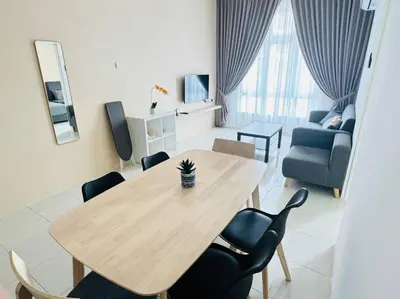 a living room with a wooden table and chairs at Ipoh Town Anderson Hani Suite 4paxs 1R1B in Ipoh