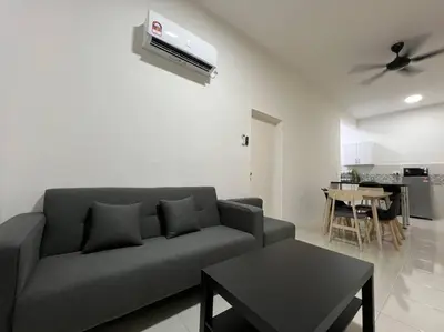 a living room with a couch and a table at Ipoh Town Anderson Hani Suite 4paxs 1R1B in Ipoh