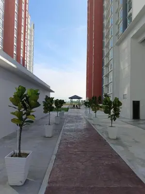 a row of potted trees on a sidewalk in a building at Ipoh Town Anderson Hani Suite 4paxs 1R1B in Ipoh