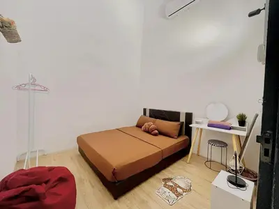 a bedroom with a bed in a white room at Home95#4pax#BukitMertajam in Bukit Mertajam