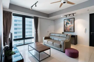 a living room with a couch and a table at Seaview Tropicana218 3BR 2CP in George Town