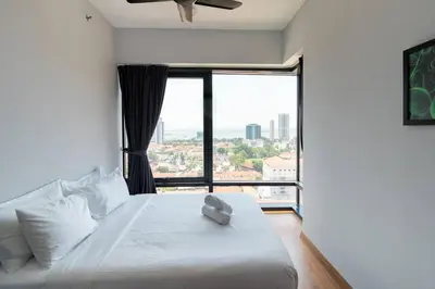 a bedroom with a white bed with a large window at Seaview Tropicana218 3BR 2CP in George Town