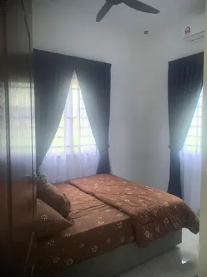 a bed in a room with a window at HomeStay Damia in Teluk Intan