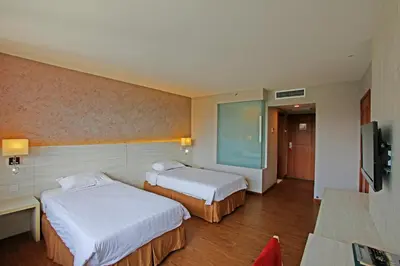 a hotel room with two beds and a television at Hotel Malaysia in George Town