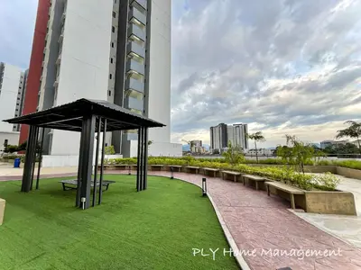 a park with benches and grass in front of a building at The Anderson Condo by PLY Home in Ipoh